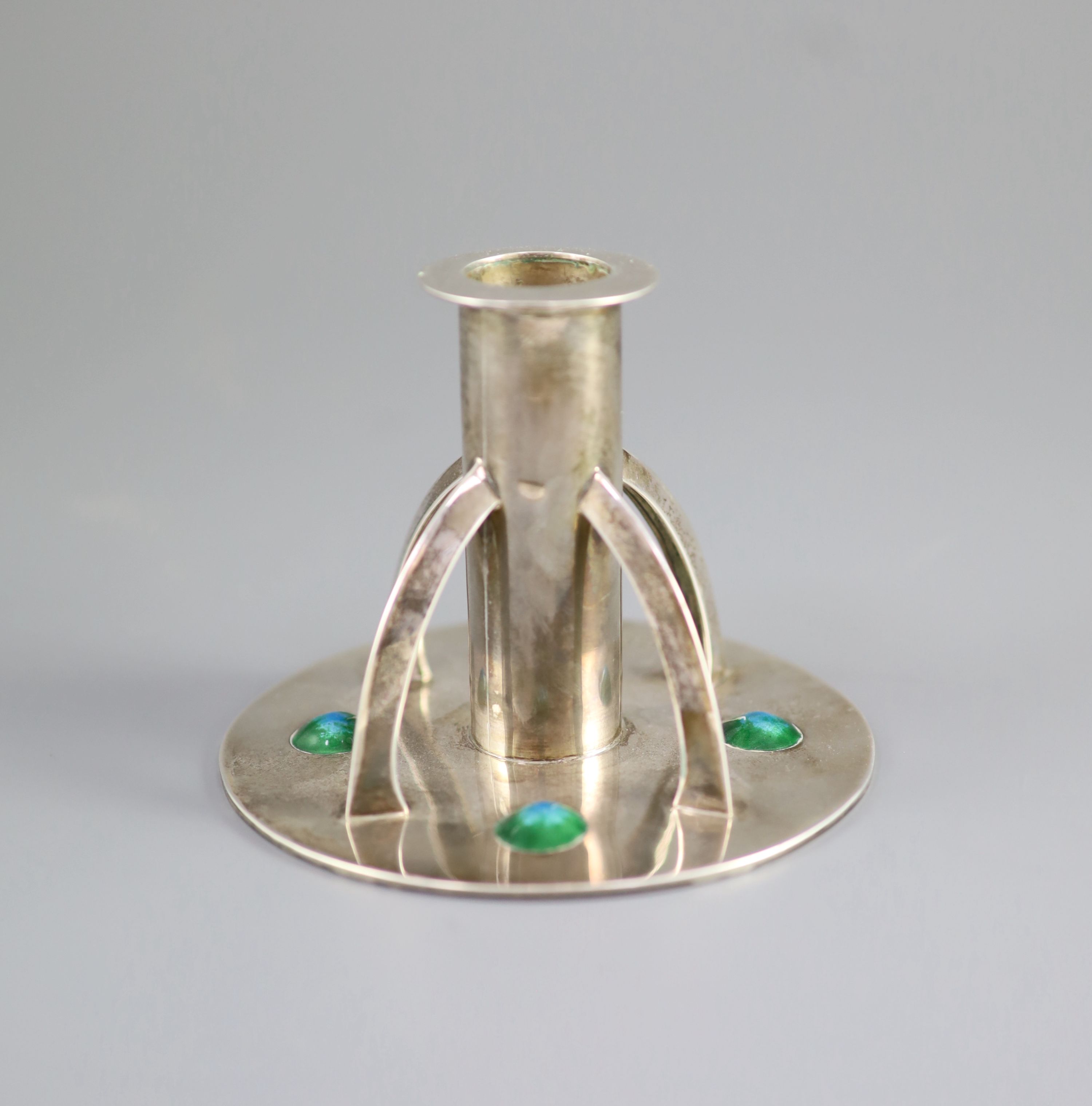 An Edwardian Arts & Crafts silver and enamelled dwarf candlestick by William Hutton & Sons